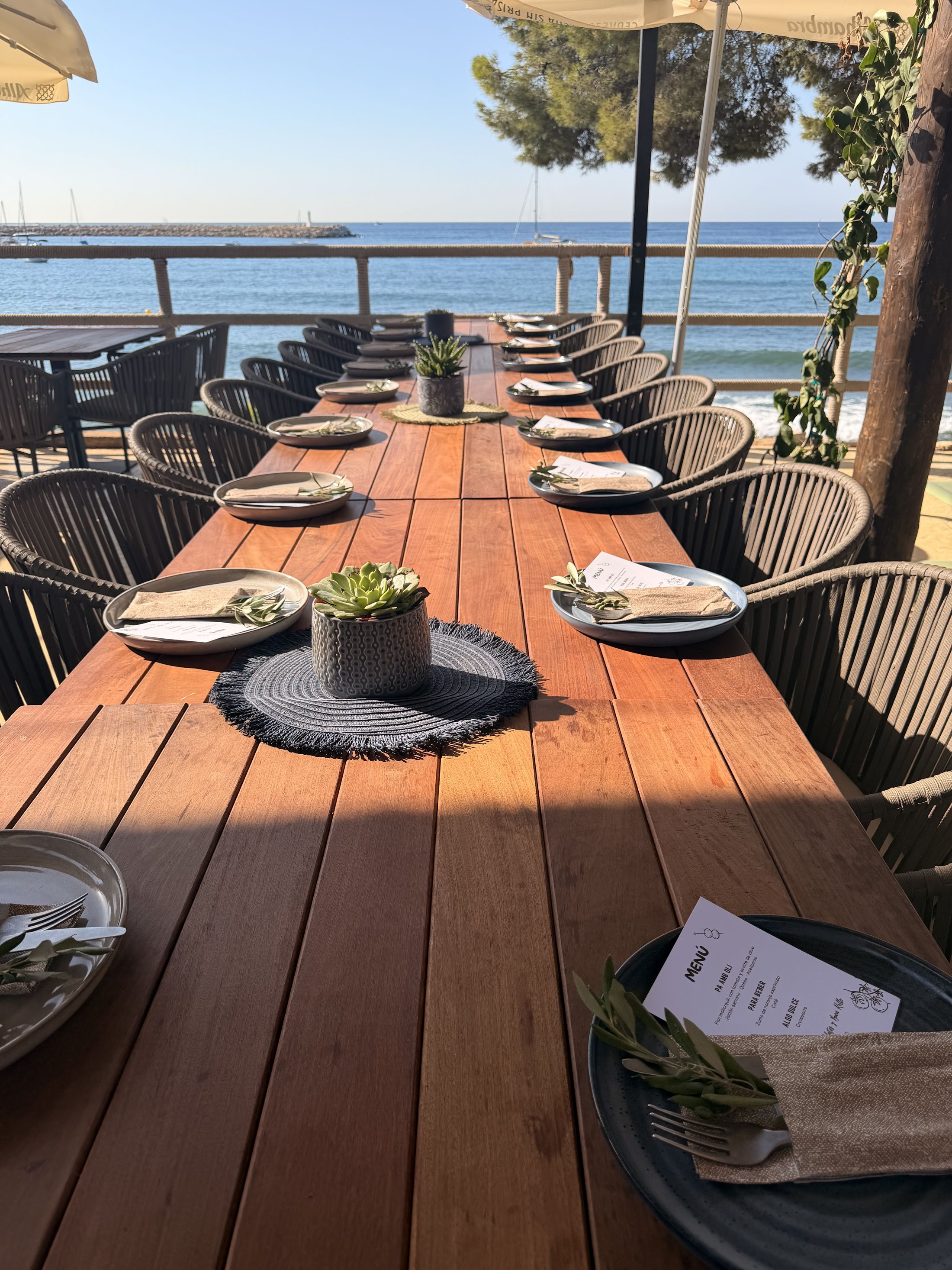 Long table set for a private lunch beside the sea in Mallorca