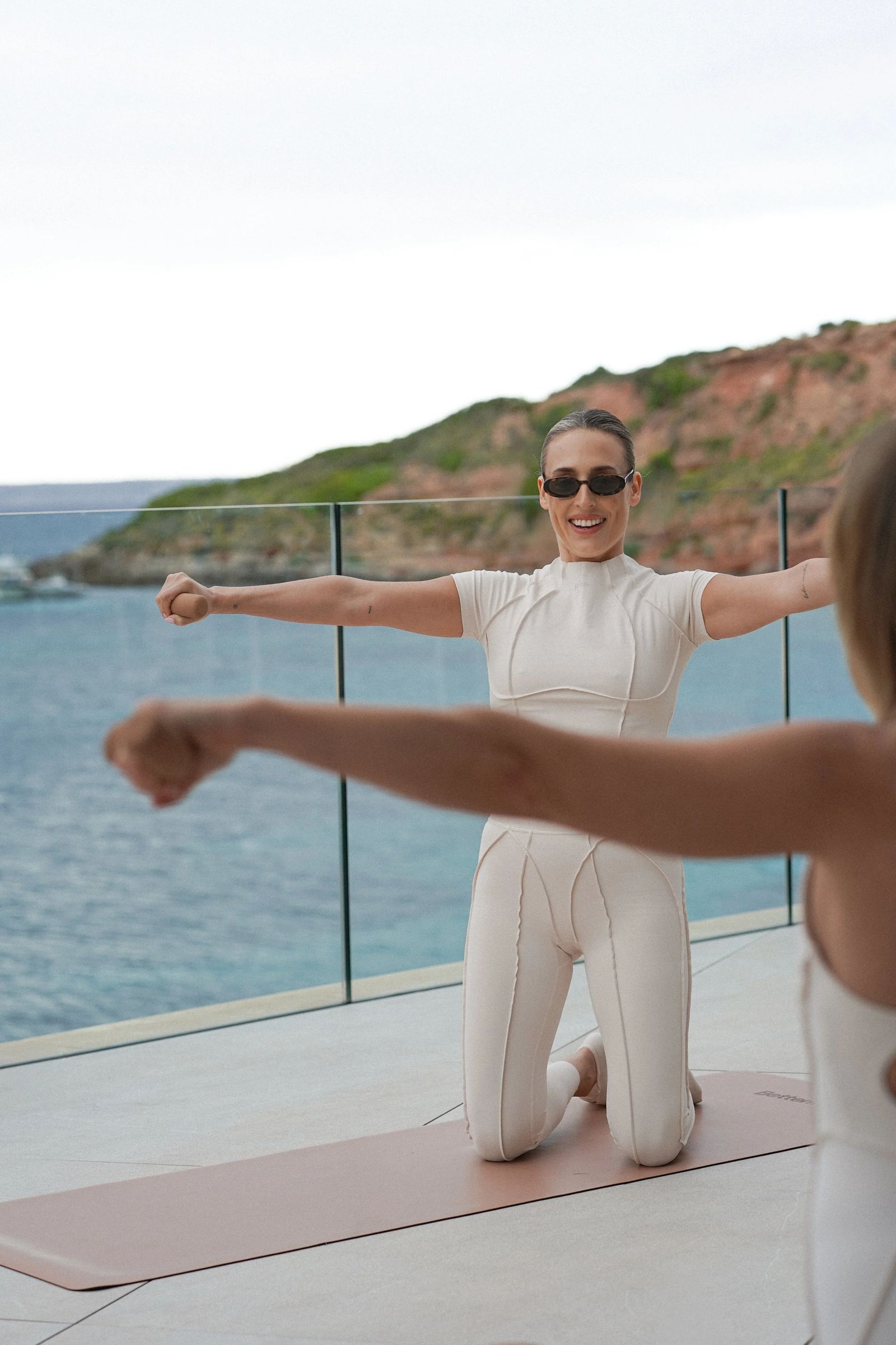 Pilates instructor practising on a rooftop with sea views in Mallorca