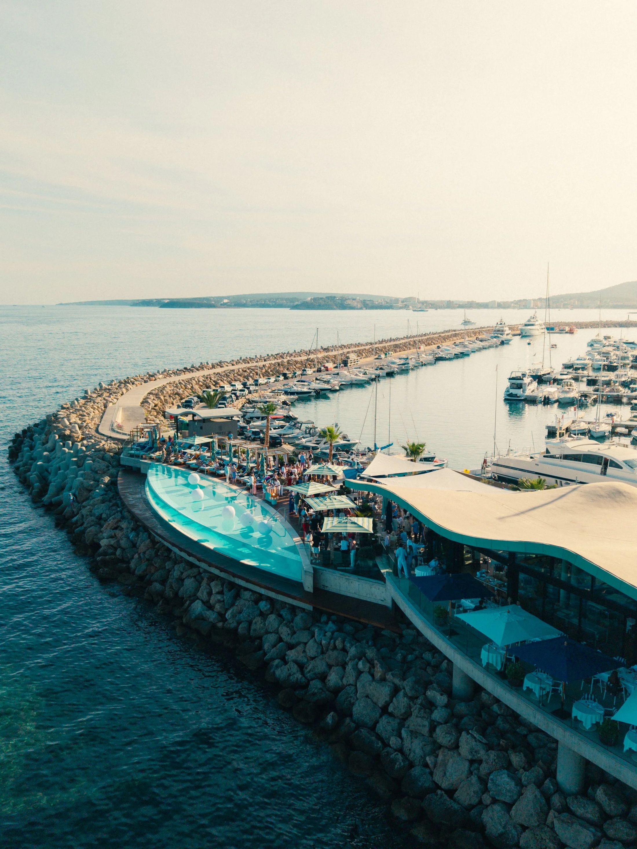 Aerial view of Puerto Portals marina and the Mediterranean coastline at golden hour, Mallorca