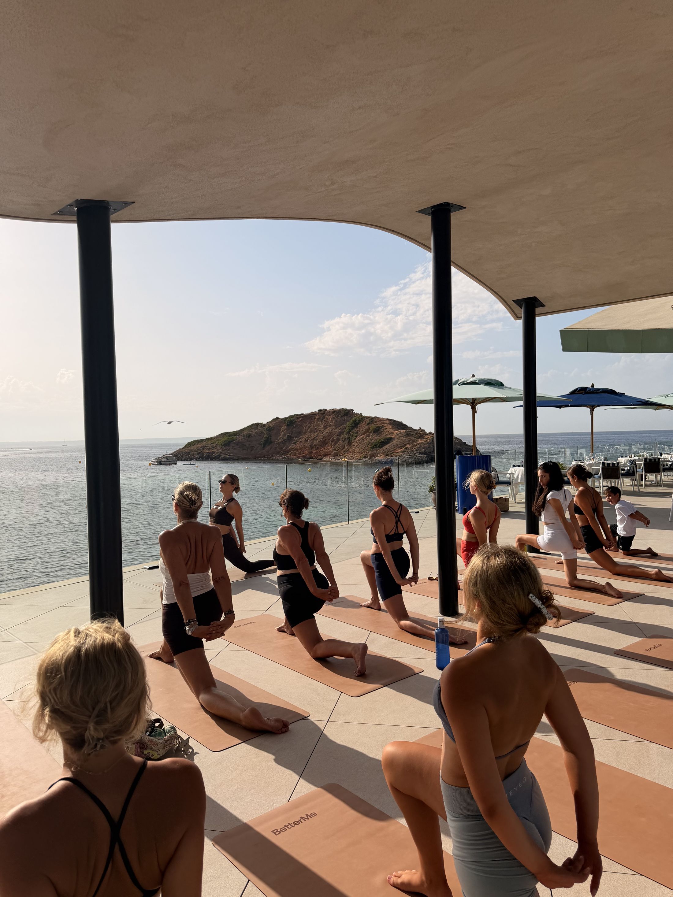 Yoga class on the seafront terrace at Lobster Club, Puerto Portals, overlooking the Mediterranean